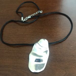 Sterling silver pendant on black fabric co…